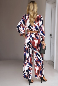 Detail view of the backless crop top and wide-leg trousers with abstract print pattern