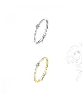 Detail of silver and gold S925 rings with micro-set square stones and engravings