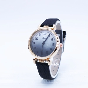 Detail of rose gold quartz watch featuring blue gradient dial and woven texture strap