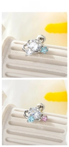 Détail de boucles d'oreilles en zircon avec formes d'étoiles et cœurs en argent poli
