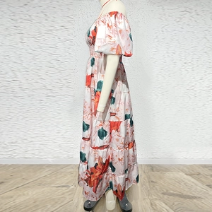 Detail of tropical floral print maxi dress with smocked waist and puffed sleeves
