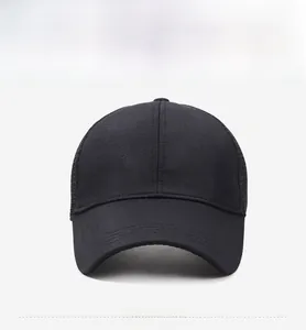 Detail of black mesh sun hat featuring a metallic gold wing shield logo on the side