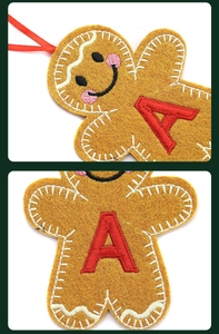 Detailed embroidery of gingerbread man ornament with red letter A and white stitching