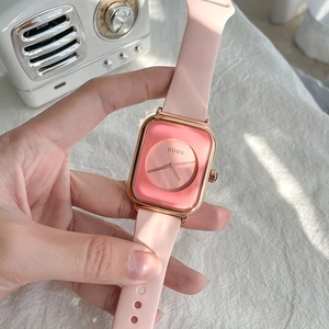 Pink minimalist square watch with silicone strap and rose gold case shown in lifestyle setting