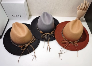 Overhead view showing gradient fedora hats with rhinestone bands and leather tassels