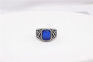 Detailed macro view of the vintage Celtic knot engravings on a blue gemstone steel ring