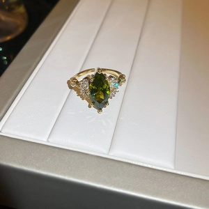 Macro shot of 14K gold plated marquise emerald ring with micro-paved diamonds detail