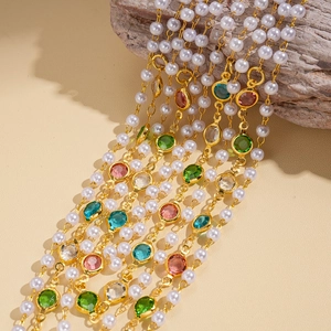 Detail of vintage layered necklace with faux pearls and colorful gemstones on driftwood