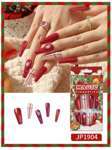Detail of Christmas press-on nails with white snowflake art and glitter on long coffin shape
