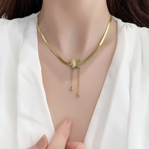 Elegant gold butterfly tassel necklace with snake chain for women, worn on neck