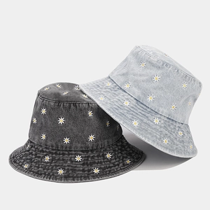 Denim bucket hats in grey and blue with white daisy embroidery and foldable design