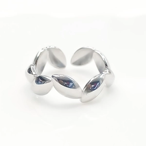 Polished silver leaf pattern open ring detail view on clean white background