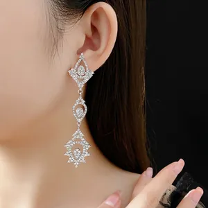 Elegant silver long hollow waterdrop earrings with full crystal pavé on female model