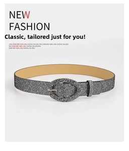 Detail of silver oval buckle with glittering sequins on a stylish women's fashion belt