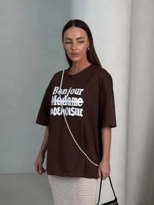 Detail of oversized brown cotton T-shirt featuring white Bonjour Madame French text print