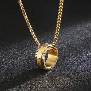 Rotatable stainless steel gold ring pendant with engraved characters on a pearl chain
