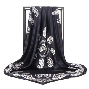 Classic black and gold paisley satin silk scarf 90x90cm hanging on a black frame