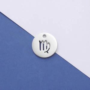 Macro view of mirror-polished silver stainless steel Virgo constellation pendant