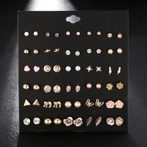 Detail view of 30 pairs of assorted stud earrings with pearls and rhinestones on black card