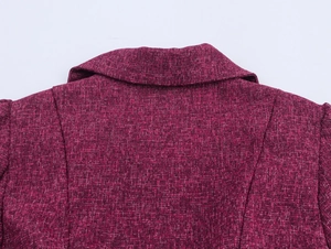 Detailed close-up of burgundy tweed fabric texture on the back collar of the jacket