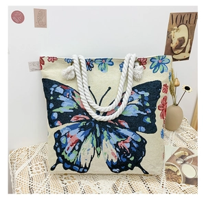 Close-up of Bohemian jacquard tote bag with blue butterfly and floral embroidery detail