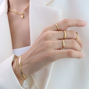 Minimalist 18K gold plated titanium jewelry set including stackable rings and necklaces