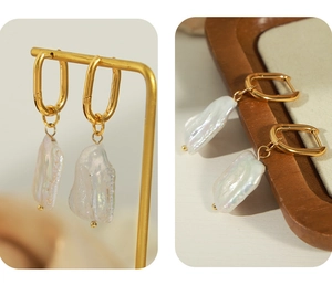 Macro detail of French style baroque pearl earrings with golden titanium steel u-shape hooks