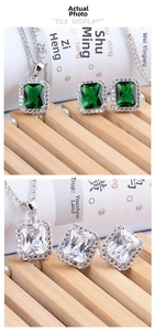 Detail of emerald cut gemstone necklace and earrings set with white zircon halo in silver