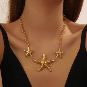 Vintage gold plated stainless steel necklace featuring three irregular starfish pendants