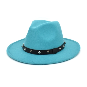 Detail of turquoise fedora hat with punk style black leather band and silver metal studs