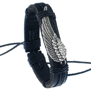 Detail of hand-woven black PU leather bracelet featuring an intricate silver metal wing