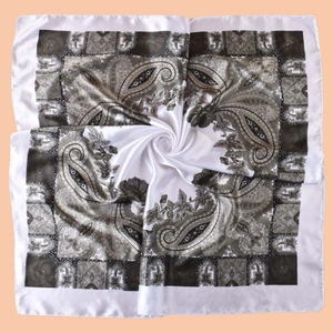 Detail view of smooth satin paisley square scarf with white and tan floral patterns