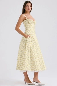 Detail of floral print pattern on a light yellow French style camisole midi dress