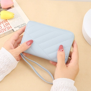 Light blue faux leather zip wallet with diagonal stitching and a matching wrist strap