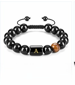 Close-up of beaded tiger eye bracelet with adjustable cord and golden letter A charm