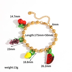 Handmade beaded fruit bracelet with cherry grape and lemon charms on white background