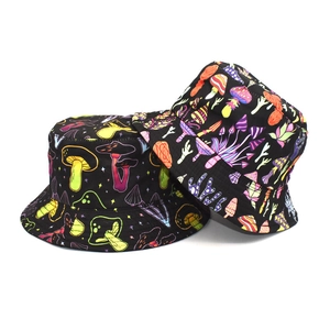 Detailed close-up showing two black bucket hats with colorful mushroom prints