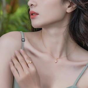 Close-up of crown-style S925 silver ring and necklace with pink quartz gemstones