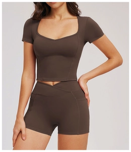 Detail of deep brown yoga set featuring sweetheart neckline top and high waist shorts