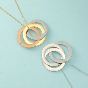 Close-up of interlocking triple ring necklace in gold, rose gold and silver finishes