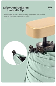 Detail view of safe blunt tips and gold handle on a mint green folding umbrella