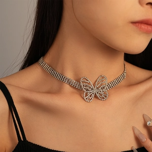Macro shot of silver butterfly choker necklace with sparkling rhinestones on female neck