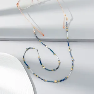 Macro shot of colorful crystal beads eyewear chain with golden hearts on glasses