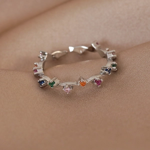 Detailed macro view of silver wavy ring band featuring multi-color micro-set zircon gems