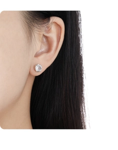 Close-up of minimalist S925 sterling silver stud earring with sparkling cubic zirconia