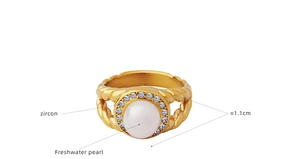 Macro shot of freshwater pearl with zircon halo on a twisted gold titanium steel ring
