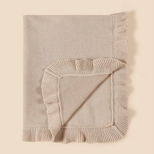 Beige cotton knit baby blanket with elegant ruffle edges for strollers and cribs