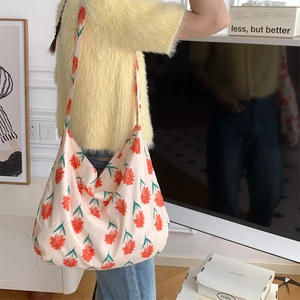 Floral canvas tote bag in pink and orange showing spacious interior and casual shoulder style