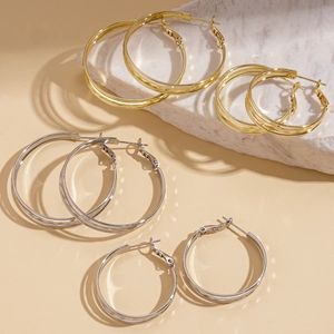 Multi-layered geometric textured gold and silver hoop earrings in various sizes