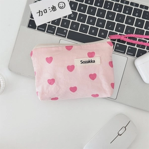 Detail of pink canvas pouch with red heart patterns and Sozakka label with top zipper